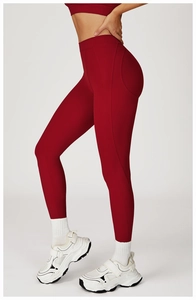 Detail view of high-waisted dark red yoga leggings with body-sculpting seam lines