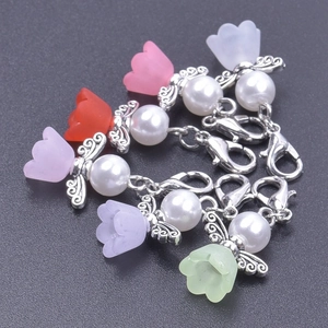 Detail of colorful angel wing pendants with lobster clasps for DIY wedding party favors