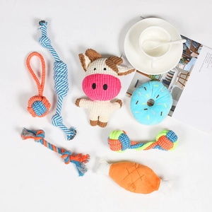 Detailed assortment of colorful dog rope toys and plush squeaky toys on white background