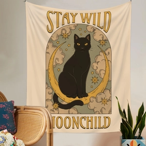 Detail of artistic black cat tapestry on moon with Stay Wild Moonchild text design