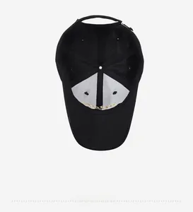 Detailed interior of a black baseball cap featuring gold embroidery and neat stitching