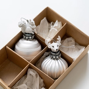 Squirrel and deer head glass Christmas ball ornaments set in a brown craft gift box
