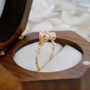 Detailed shot of S925 silver petal ring with opal and stones in a wooden gift box