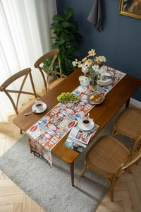 Detail of colorful jacquard table runner with fishbone patterns and fringe tassels