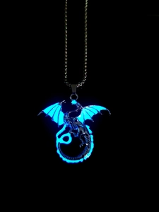 Detailed view of flying dragon necklace with vibrant blue glow in the dark effect