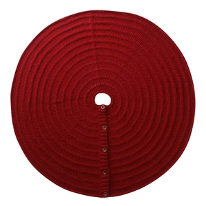 Detail of red knitted Christmas tree skirt with textured pattern and five dark buttons