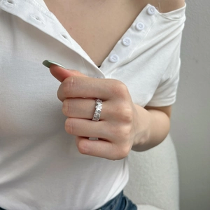 Detailed view of S925 sterling silver ring with oval and rectangular zircon stones on hand