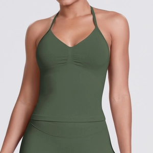 Close-up of seamless dark green halter yoga top showing V-neck and ribbed fabric texture