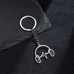 Polished silver stainless steel keychain with headphone and heartbeat pendant on dark stone