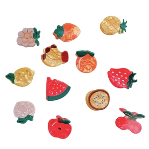 Set of 12 colorful fruit hair claws including grape carrot pineapple and strawberry shapes