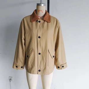 Detail of khaki cotton jacket with brown corduroy collar and large utility flap pockets