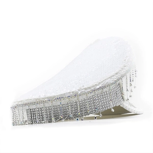 Detail of white sequined captain hat featuring shimmering rhinestone fringe and crystal tassels
