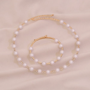 Elegant gold jewelry set featuring faux pearl and crystal necklace with matching bracelet