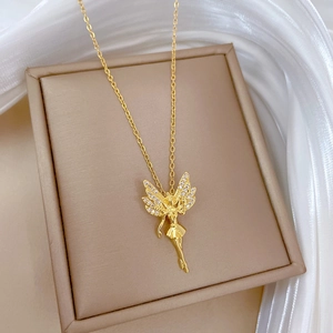 Elegant gold butterfly fairy pendant necklace with crystals on a beige jewelry display