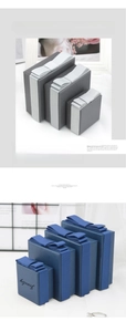 Detailed view of gray and blue jewelry gift boxes with bows and fine texture