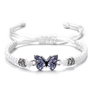 Detail of white woven rope bracelet with blue butterfly pendant and rhinestone accents