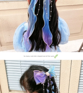Detail of blue purple gradient organza bow hair clip with pearl fringe and gold trim