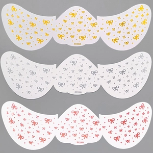 Macro detail of bronzing freckle facial tattoo stickers in gold, silver, and pink