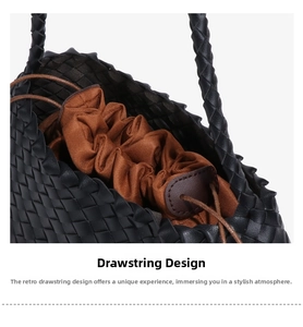Detail of hand-woven black leather tote with a brown drawstring lining and woven handle