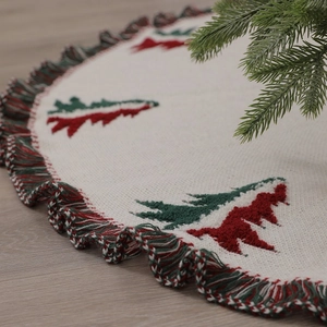 Knitted Christmas tree skirt with red and green embroidered trees and festive fringe trim