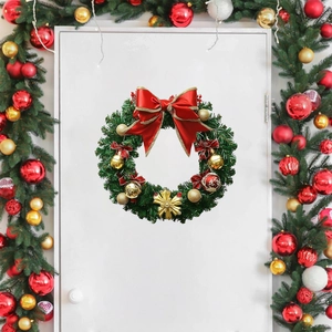 Classic Christmas wreath with red bows and gold ornaments hanging on a white wooden door