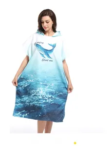 Detailed close-up of whale print and surfing text on microfiber hooded beach poncho