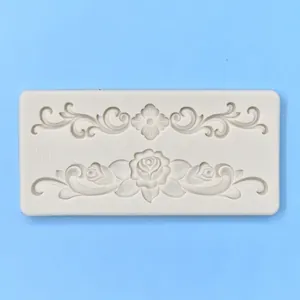White silicone cake mold with embossed rose and scroll patterns for fondant crafting