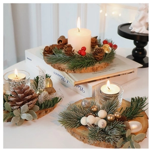 Close-up of Nordic Christmas wooden log candle holder with pine needles and red berries