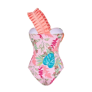 Detail of ruffle shoulder design on one-piece floral swimsuit with tropical palm leaf print