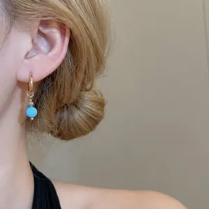 French vintage necklace and earring set with turquoise and zircon pendant on a model