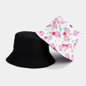 Detail of cotton bucket hats featuring dense stitching and vibrant fruit pattern print