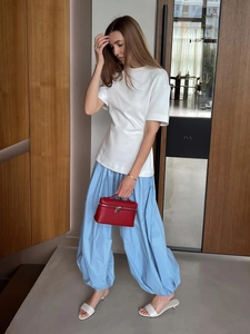 Sky blue cotton harem pants paired with a white tee and red leather handbag for summer