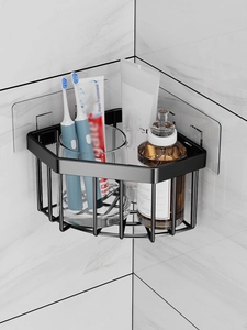 Close-up of matte black stainless steel corner shelf mounted on marble wall