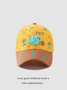 Close-up of yellow and brown kids baseball cap with 3D dinosaur patch and stitching detail