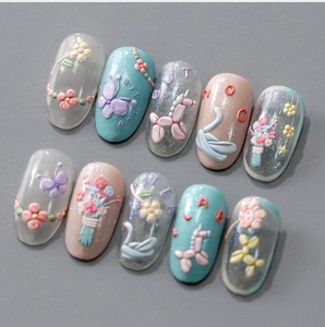 Macro shot of 3D embossed nail stickers featuring butterfly and unicorn patterns