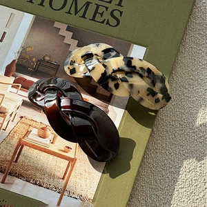 Close-up of French style twisted chain hair clips with amber and tortoiseshell patterns