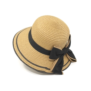 Elegant wide-brim straw sun hat for women featuring a stylish black ribbon bow detail