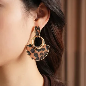 Maillard style leopard heart fan drop earrings in gold alloy worn by a model