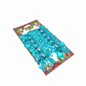 Set of 12 metallic bright blue Christmas tree decoration bows on festive red cardstock