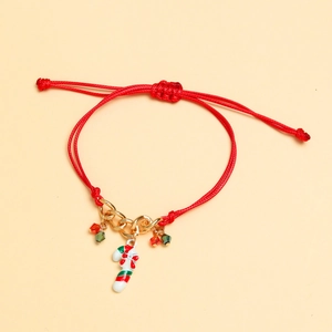 Macro detail of red woven Christmas bracelet with candy cane charm and gold chain links