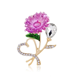 Detailed macro of a purple enamel flower brooch with crystals on a golden metal stem