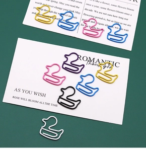 Macro shot of colorful duck-shaped metal paperclips in multiple vibrant coated finishes