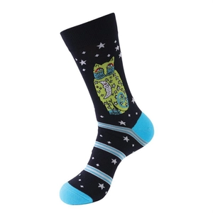 Detail view of navy crew sock featuring green cat and celestial pattern with blue accents