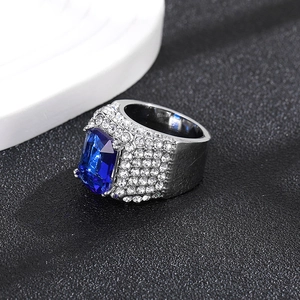 Luxurious hip-hop ring with emerald-cut blue zircon and pavé crystals on silver metal