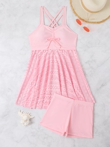Detail of pink two-piece swimsuit with lace skirt and adjustable drawstring bow