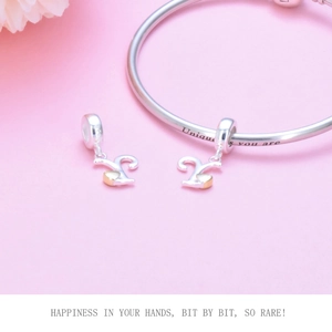 Detail of S925 sterling silver heart charms and bangle with Unique You Are engraving