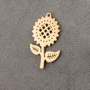 Macro detail of golden stainless steel sunflower pendant with mirrored finish for DIY jewelry
