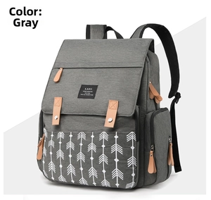Detailed side view of the grey LAND diaper backpack with arrow pattern and leather zippers
