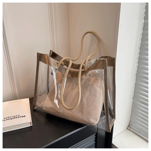 Detail of transparent PVC tote bag featuring rope handles and internal fabric pouch