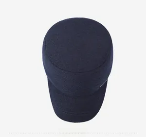 Top view of navy blue wool flat cap showing high-quality fabric texture and metal detail